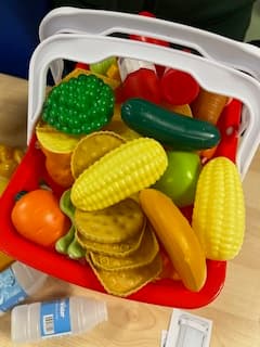 Shopping-themed games used to anchor French vocabulary in a primary class in Weybridge.